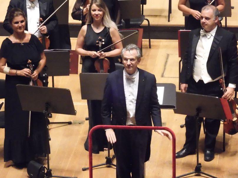 Filharmonični orkester milanske Scale na odru, mi pa z maskami